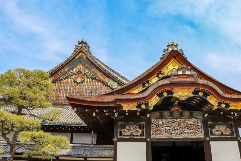 Kyoto temple architecture with ornate wooden eaves, gold embellishments, and a curved roof, showcasing historic Japanese craftsmanship at a Kyoto temple, Japan.Kyoto Tourist Attractions