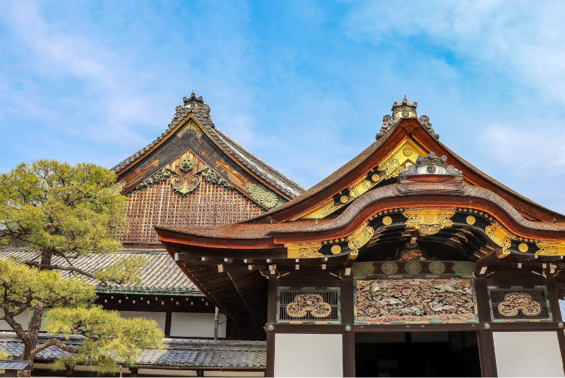 Kyoto temple architecture with ornate wooden eaves, gold embellishments, and a curved roof, showcasing historic Japanese craftsmanship at a Kyoto temple, Japan.Kyoto Tourist Attractions