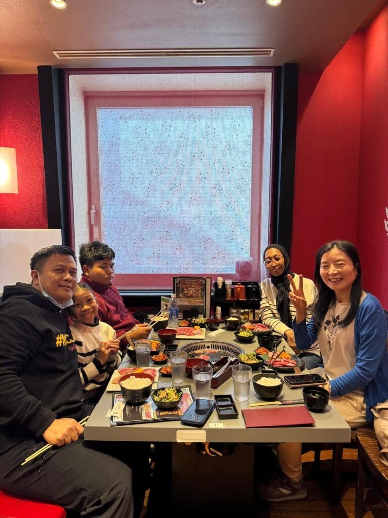 whatsapp-image-2025-07-15-at-10-26-51-am-1 Group of five people seated at a table in a restaurant enjoying a meal together.